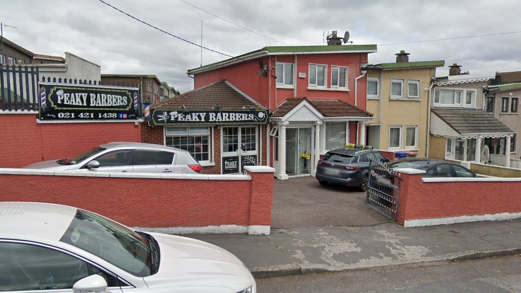 The Peaky Barbers shopfront at 7 Knocknaheeny Avenue, Cork, with parking in front